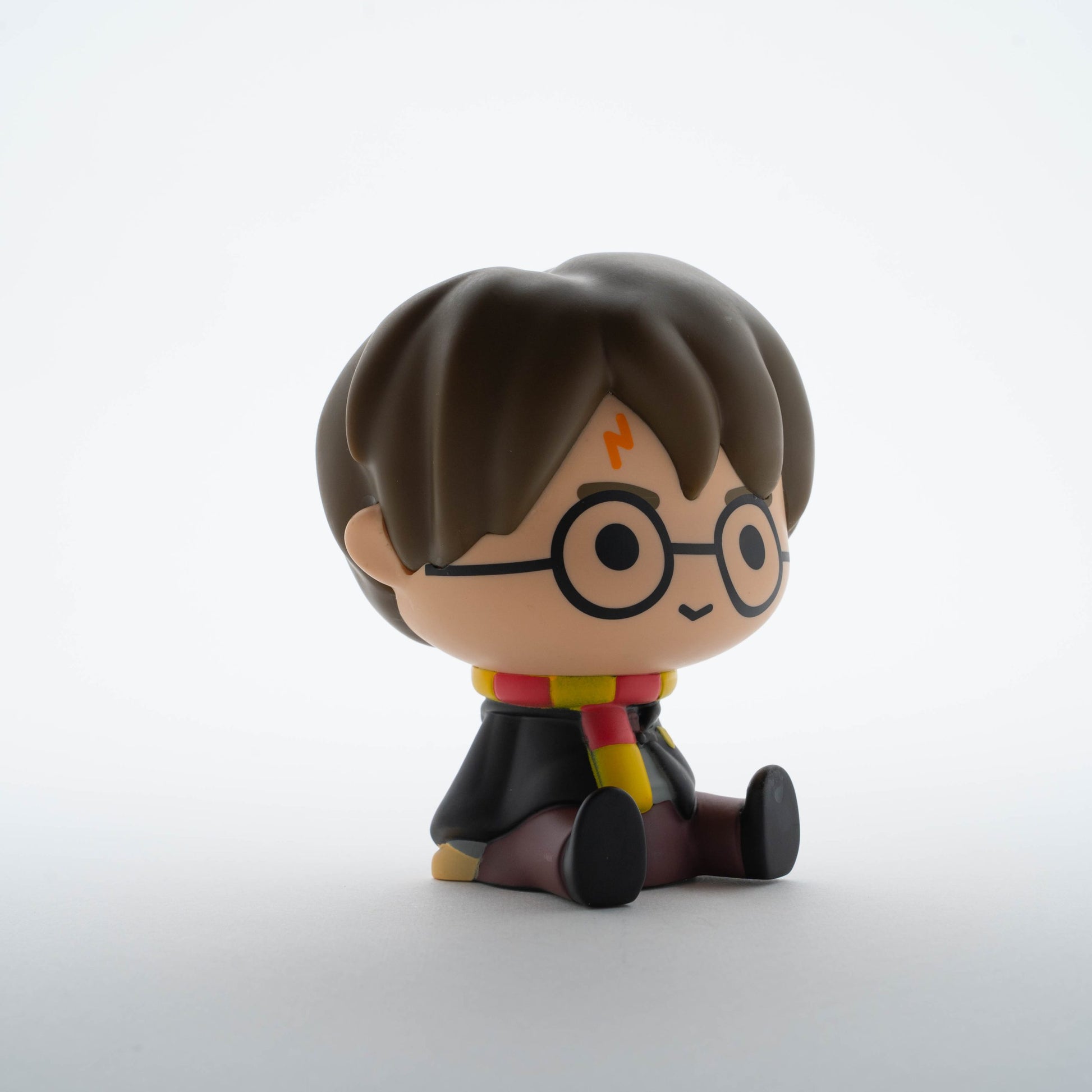 Skarbonka Harry Potter w stylu figurki z okularami i szalikiem w barwach Gryffindoru