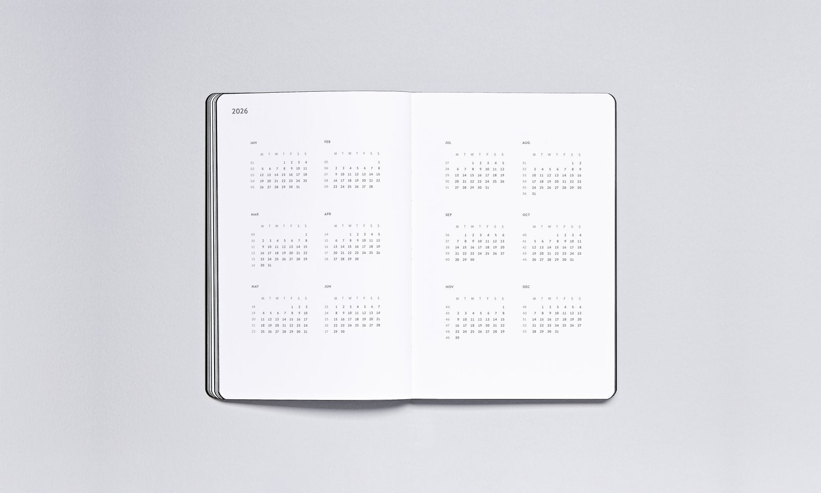 Minimalistyczny kalendarz tygodniowy 2025 otwarty na widok roczny z małymi miesiącami