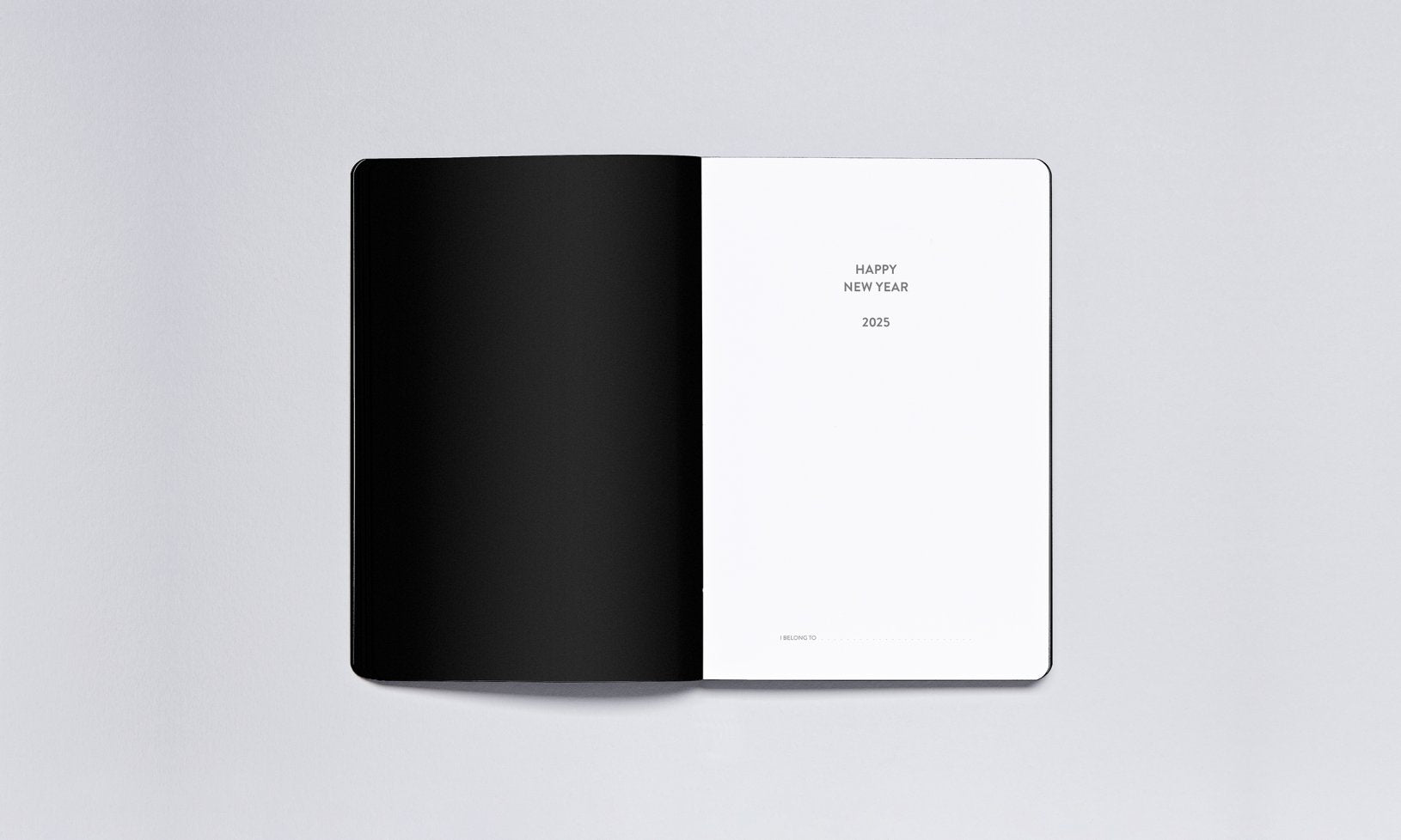 Minimalistyczny kalendarz tygodniowy 2025 otwarty na stronie powitania nowego roku