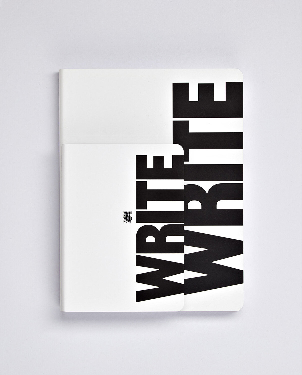 Notatnik graphic L BV JACOB COMPANY z białą okładką i dużym czarnym napisem WRITE