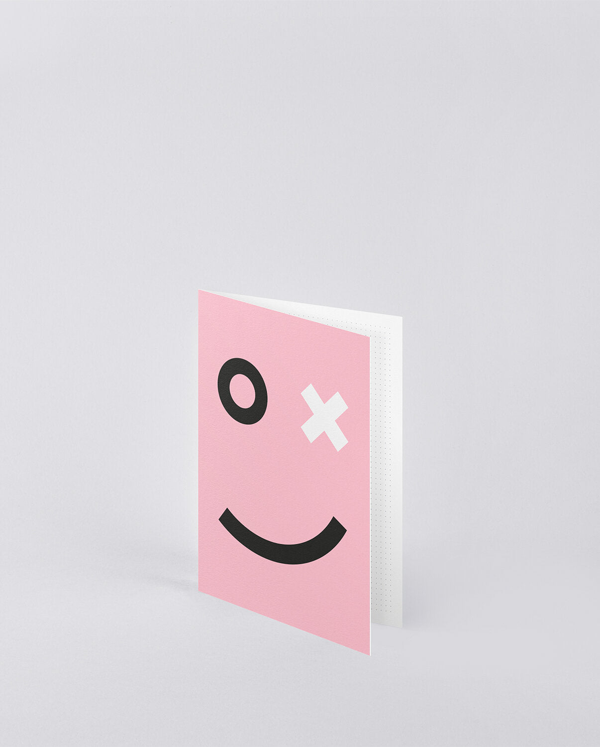 Oryginalna kartka okolicznościowa różowa z kreskówkową buźką i jednym okiem w kształcie litery O