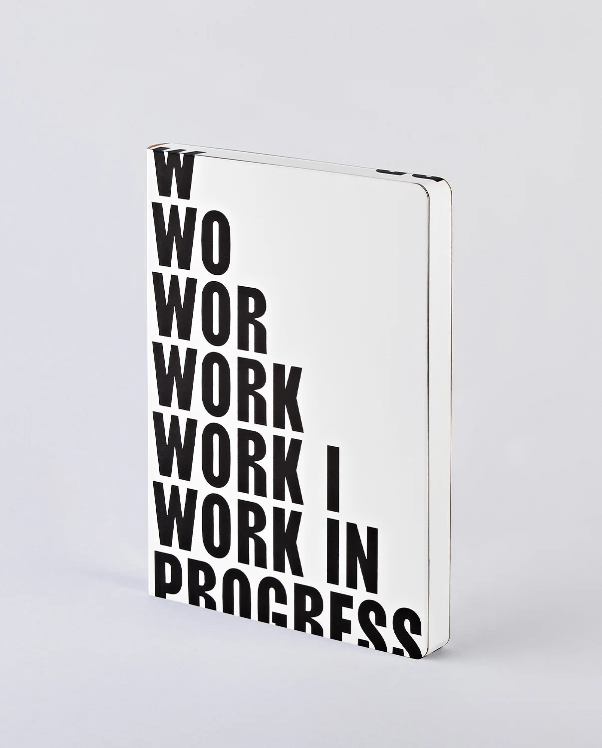 Notatnik work in progress BV JACOB COMPANY z białą okładką i czarnym dużym napisem na froncie