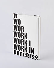 Notatnik work in progress BV JACOB COMPANY z białą okładką i czarnym dużym napisem na froncie