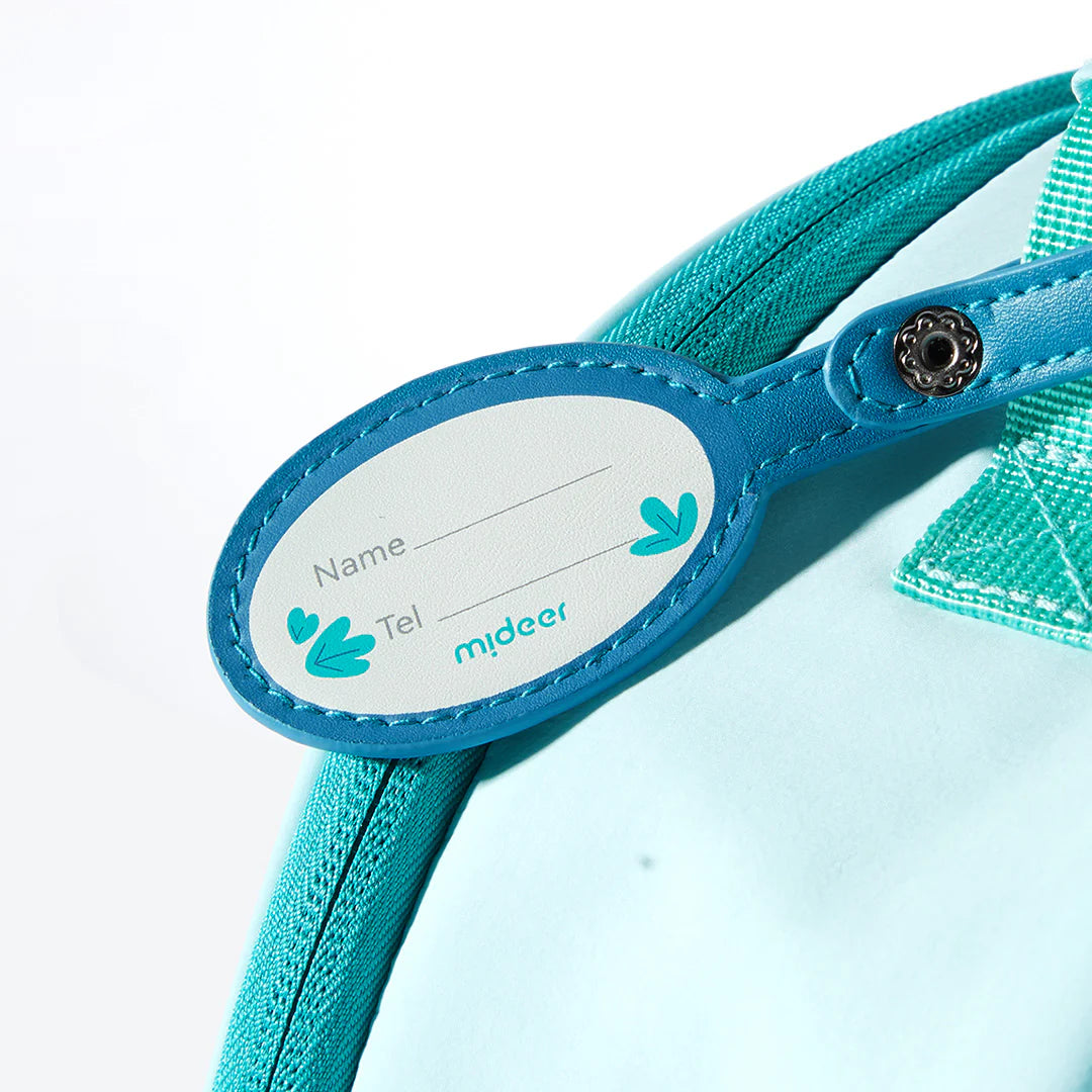 Zbliżenie na niebieską metkę na plecak dla dzieci koala marki mideer z miejscem na imię i telefon