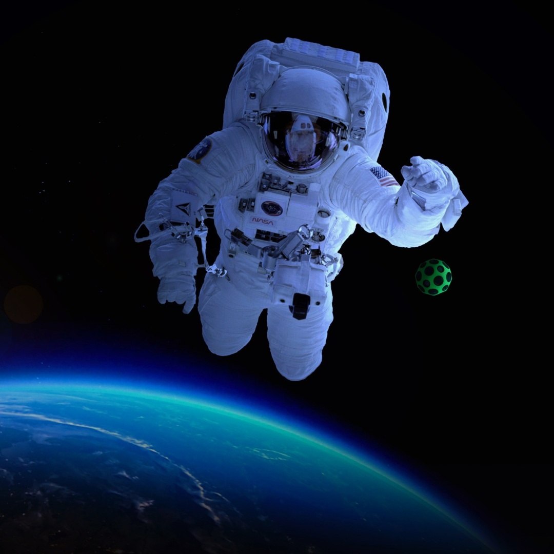 Astronauta w kosmosie trzymający niebieską piłeczkę Waboba Moon Ball niebieska nad Ziemią