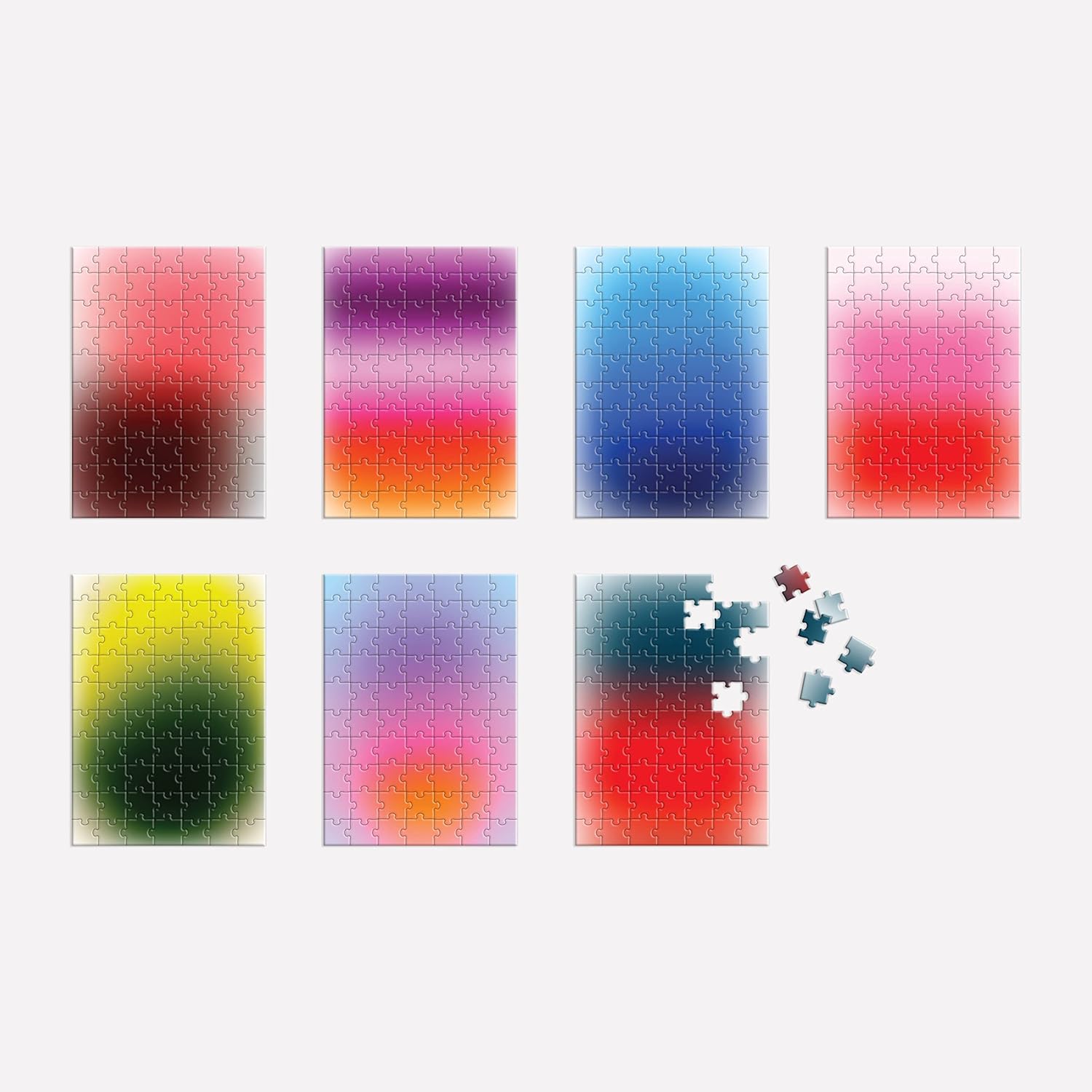 Zestaw siedmiu obrazów puzzle mindfulness 500 elementów z kolorowymi gradientami i kilkoma rozłożonymi puzzlami