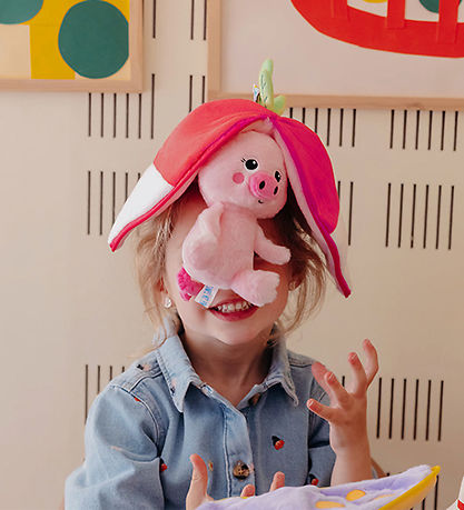 maskotka flipetz świnka rzodkiewka trzymana przez dziecko z uśmiechem w pokoju zabaw