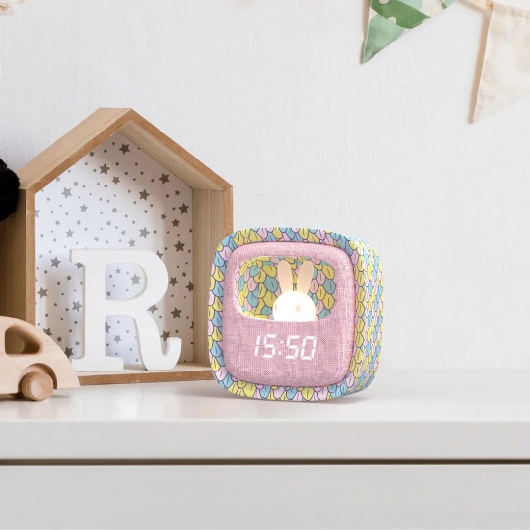 Kolorowy budzik dla dzieci z lampką w kształcie królika na białym biurku