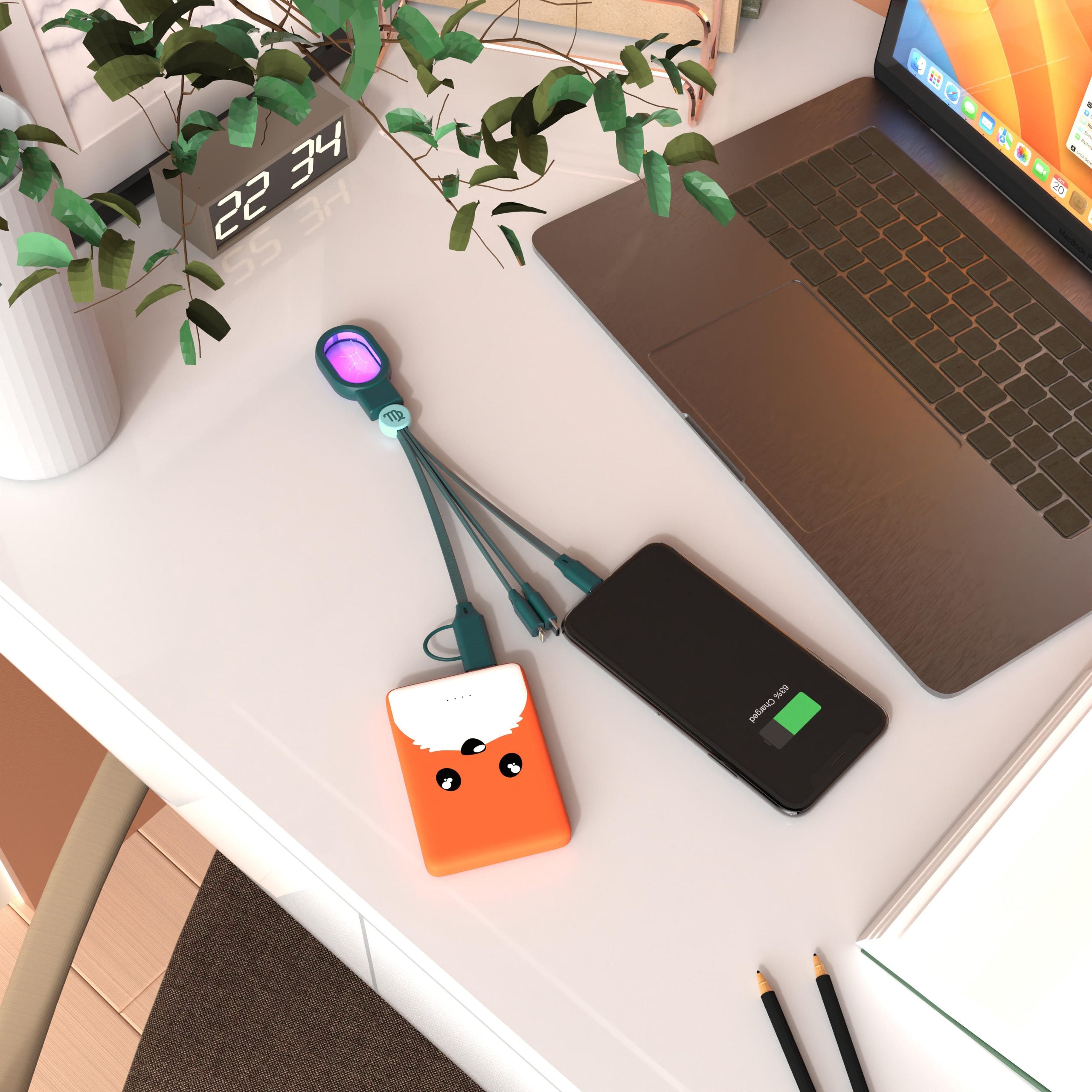 kabel 5 w 1 do ładowania podłączony do powerbanku i smartfona na biurku obok laptopa