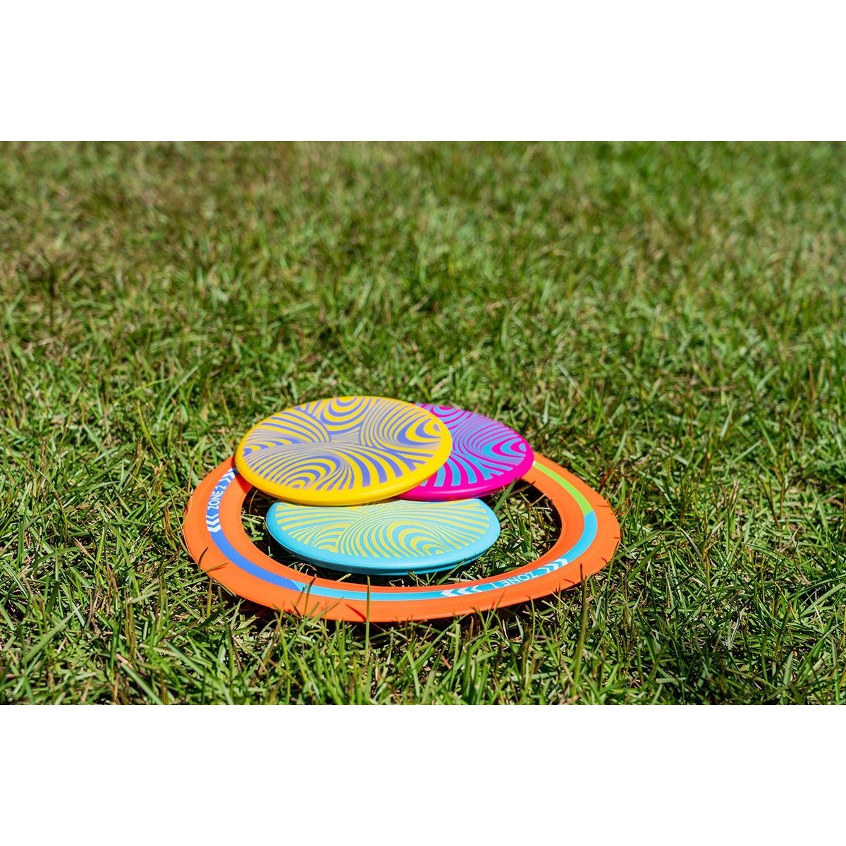Kolorowa gra Waboba Backnine z dyskami i pomarańczową obręczą na trawie do zabawy na świeżym powietrzu