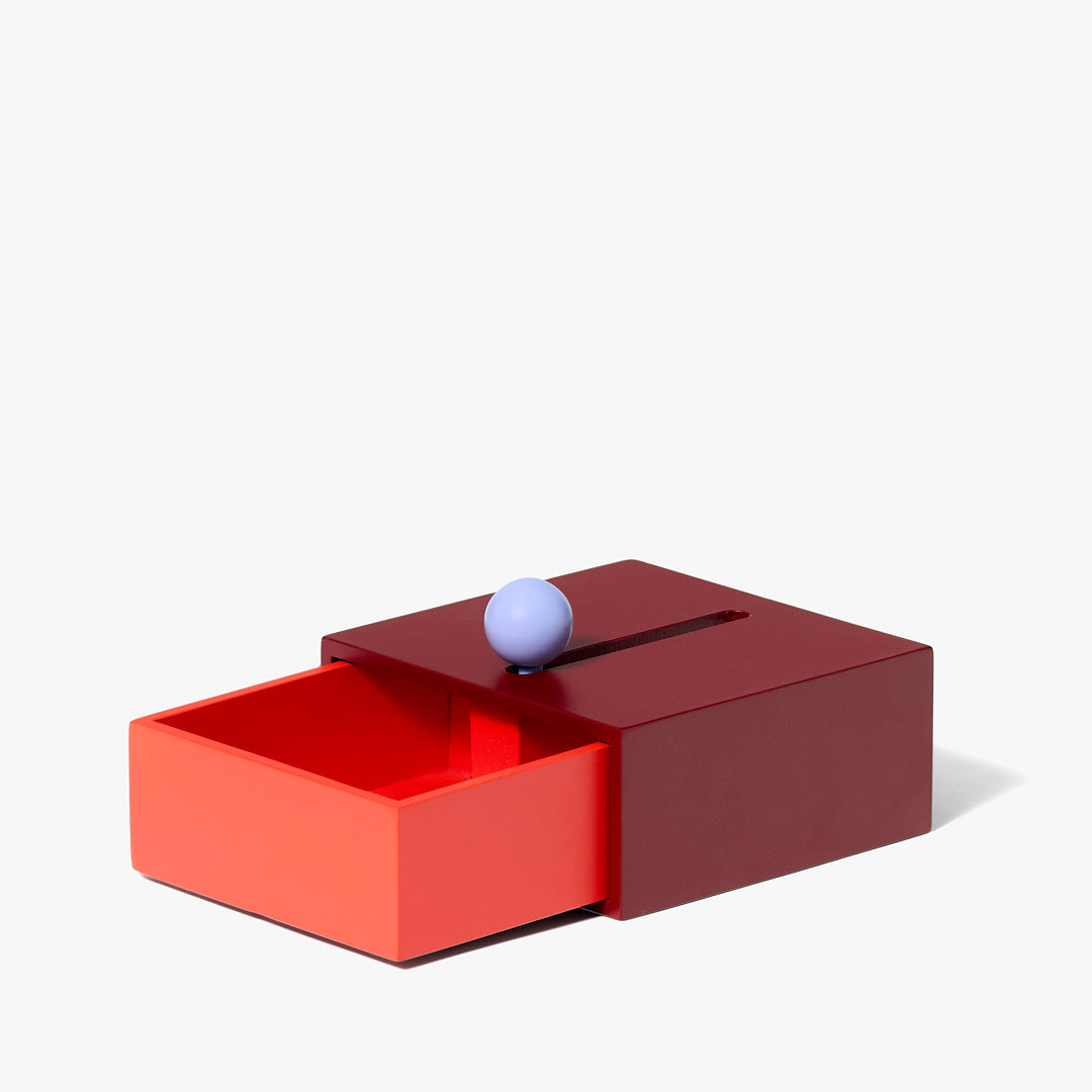 Pojemnik Cache Box Areaware czerwono-pomarańczowy z kulką do otwierania szuflady