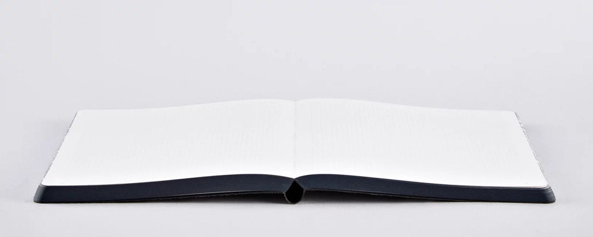 Notatnik London od BV Jacob Company otwarty na białych pustych stronach z czarną oprawą