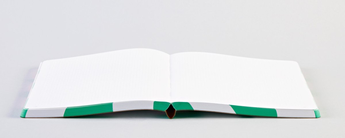 Otwarty notatnik graficzny A5 z czystymi białymi stronami na płaskim tle