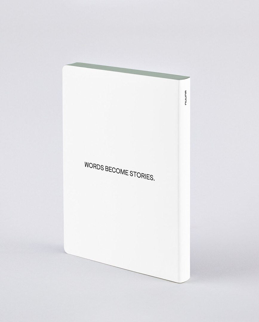 Biały notatnik Graphic L Words by Heyday z napisem Words Become Stories minimalistyczny design