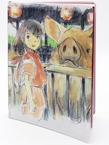Notatnik Spirited Away z ilustracją postaci Chihiro i prosiaka na okładce
