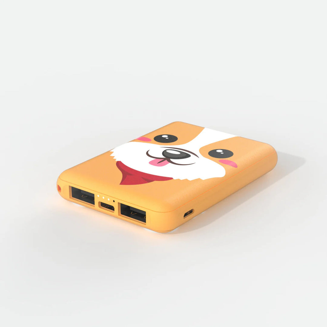 Powerbank piesek corgi w kształcie żółtego urządzenia z portami USB i uroczym psem corgi na obudowie