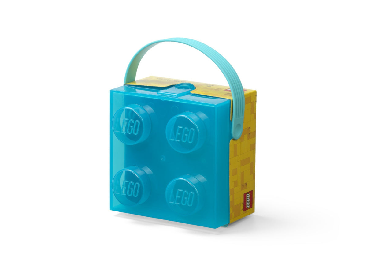 Przezroczysty lunchbox LEGO dla dzieci w kształcie klocka z niebieską rączką i żółtą podstawą