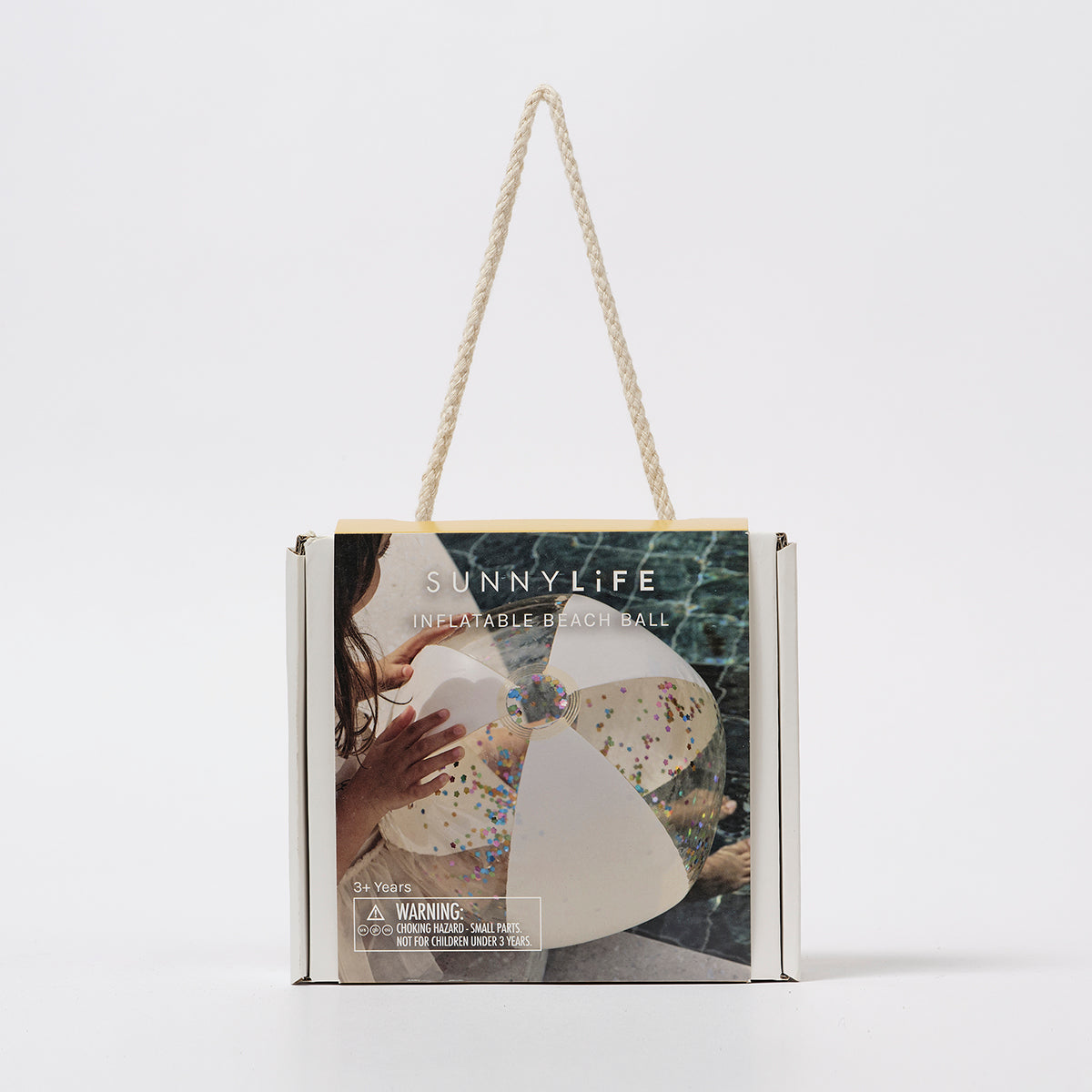 Nadmuchiwana piłka plażowa z brokatem marki LOQI w przezroczystym opakowaniu z uchwytem sznurkowym