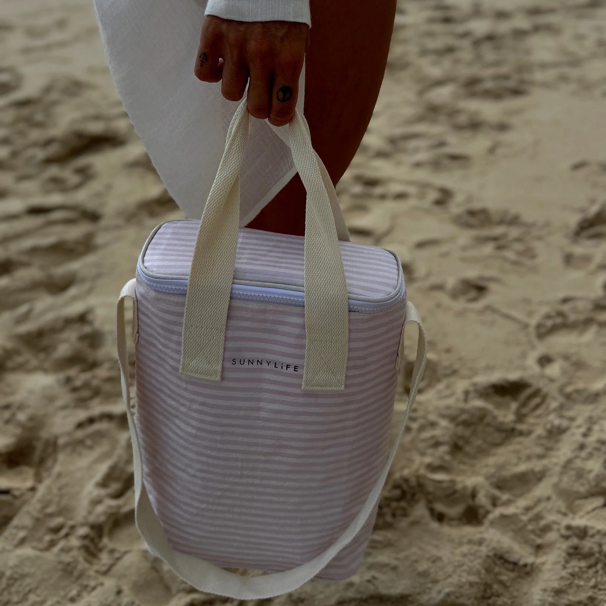 LOQI lekka torba chłodząca na napoje w biało-różowe paski, noszona na plaży