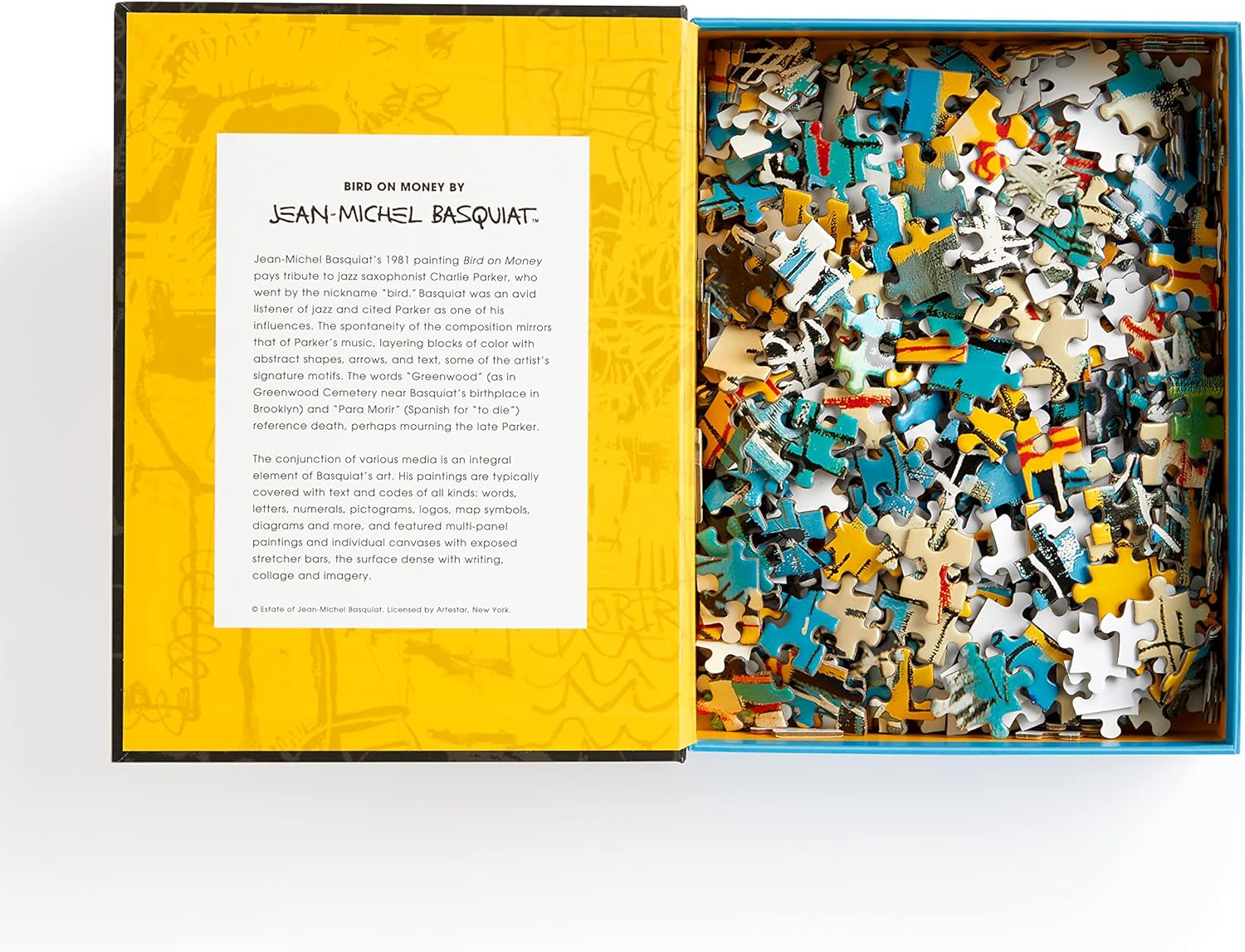 Puzzle Jean-Michel Basquiat 500 elementów w otwartym pudełku z kolorowymi kawałkami puzzli i opisem artysty