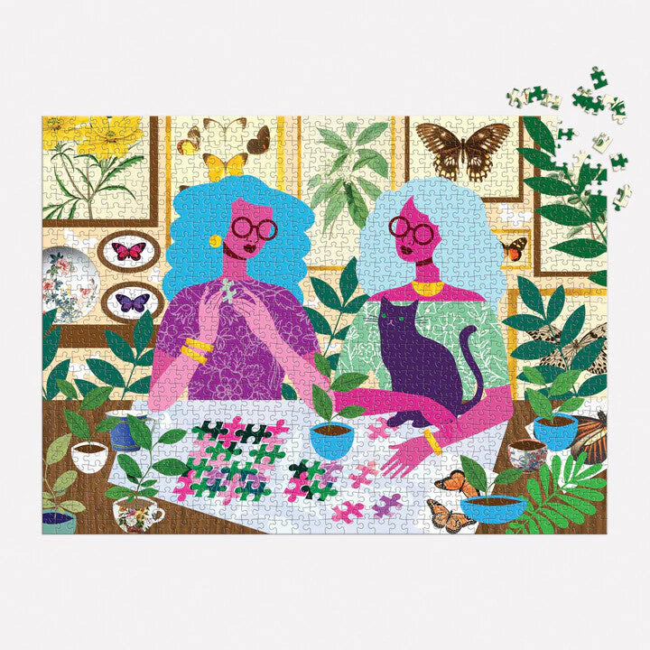 Kolorowe puzzle 1000 elementów dla dorosłych przedstawiające dwie kobiety układające obrazek w otoczeniu roślin i motyli