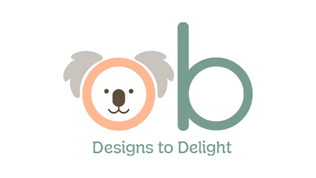 Logo zabawki OB Designs przedstawiające uśmiechniętą głowę misia w pastelowych kolorach