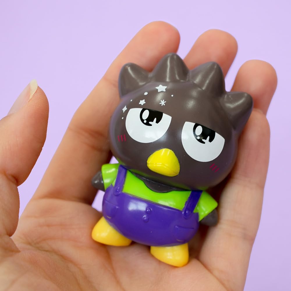 Badtz-Maru Hello Kitty figure held in hand wearing purple pants against a light purple background