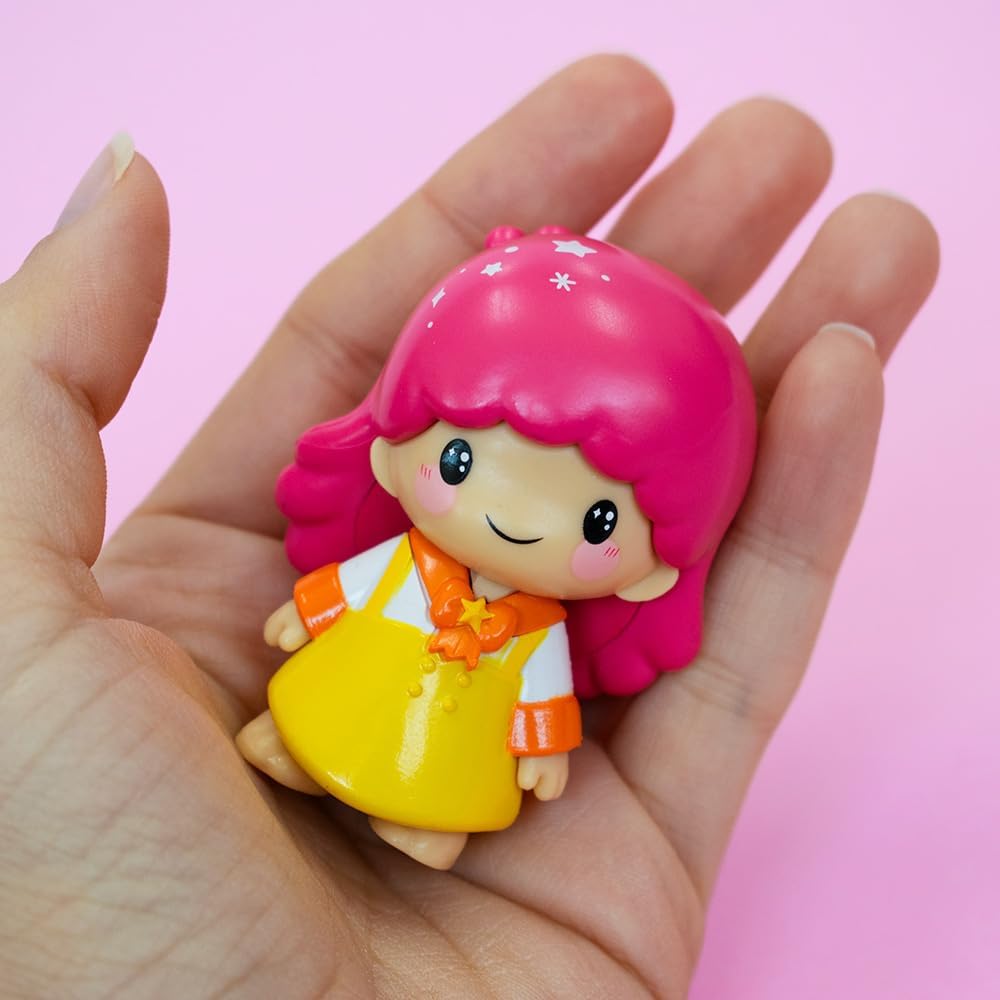 Hello Kitty kawaii figure with pink hair and a yellow dress held in hand