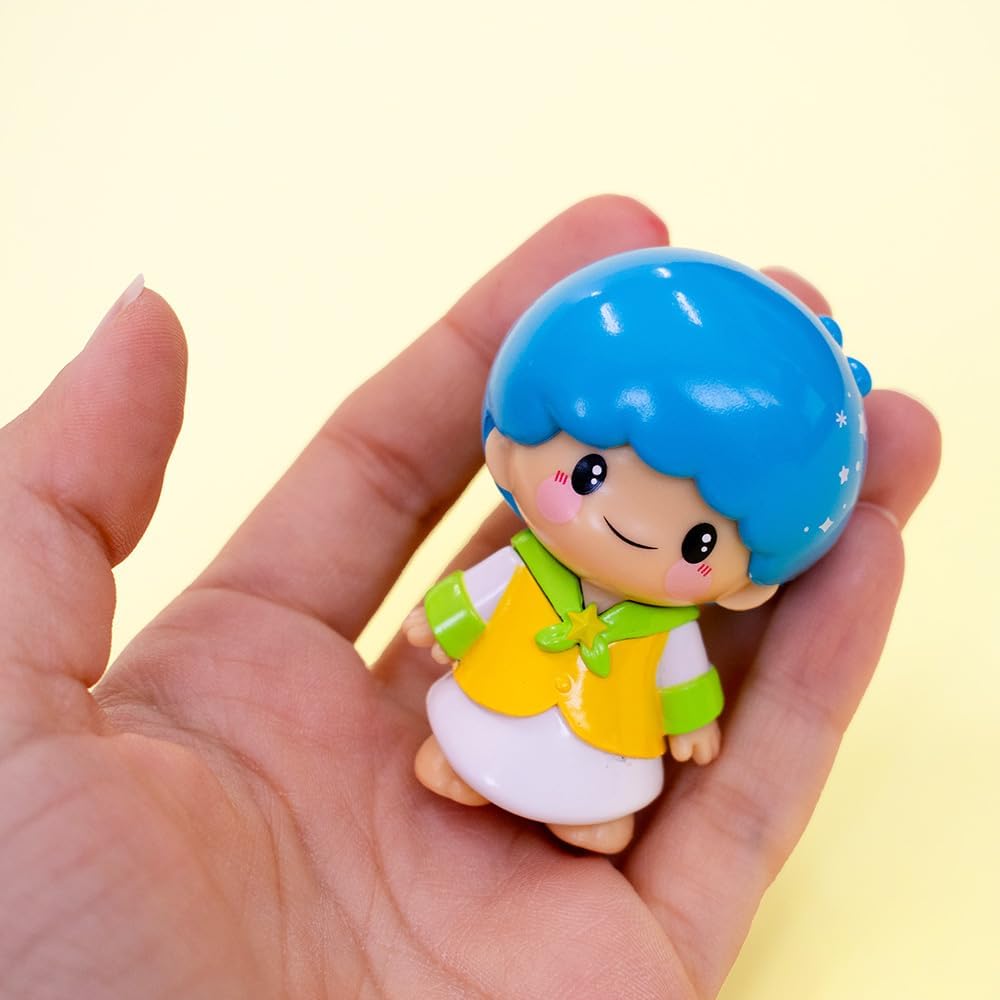 Small Hello Kitty Kawaii figure with blue hair held in hand against a light background
