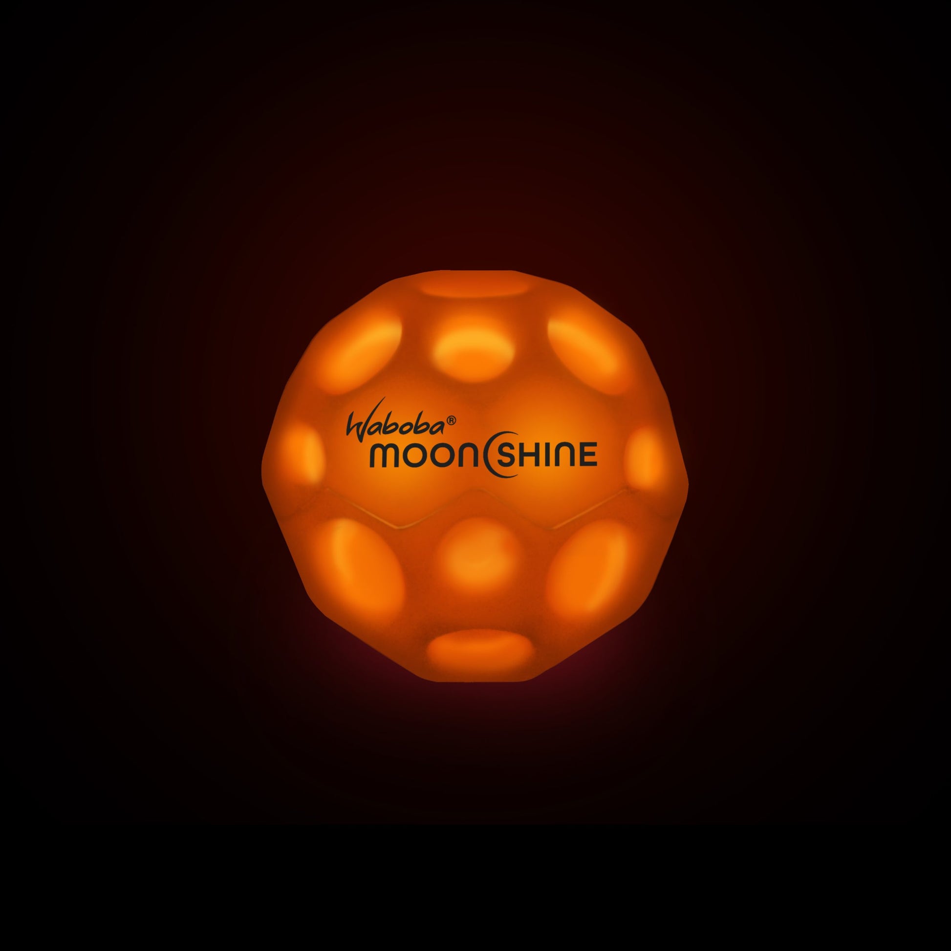 Pomarańczowa piłeczka świecąca Waboba Moonshine świecąca w ciemności z logo Waboba Moonshine