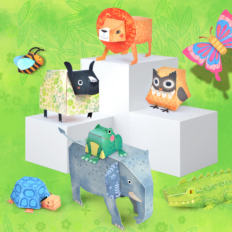 Kolorowe origami papierowe zwierzęta przedstawiające lwa, sowę, słonia, żabę, krokodyla i pszczołę na zielonym tle