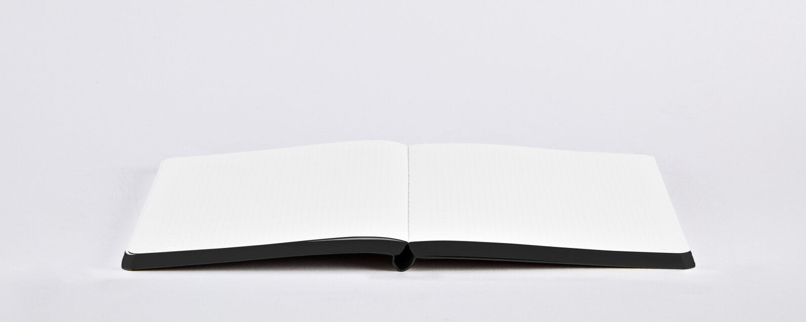 Notatnik artystyczny BV JACOB COMPANY otwarty na pustych stronach z czarną okładką