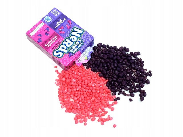 Nerds grape strawberry candies in a Yamann package scattered on a white background