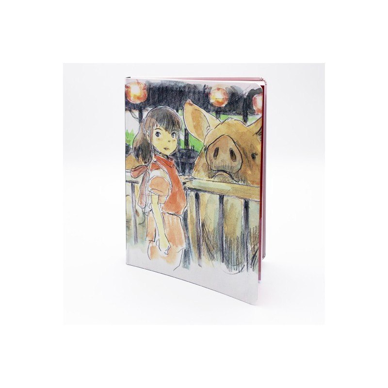Notatnik Spirited Away z ilustracją dziewczynki i dużej świni na okładce