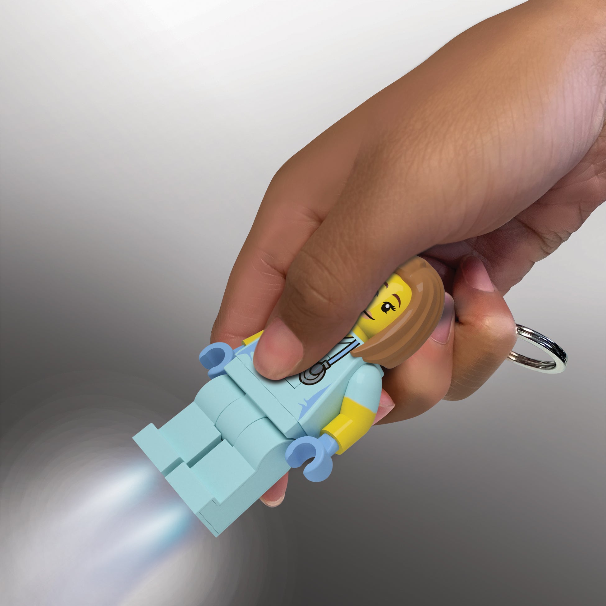 Brelok LEGO weterynarka w jasnoniebieskim stroju medycznym z latarką w ręku